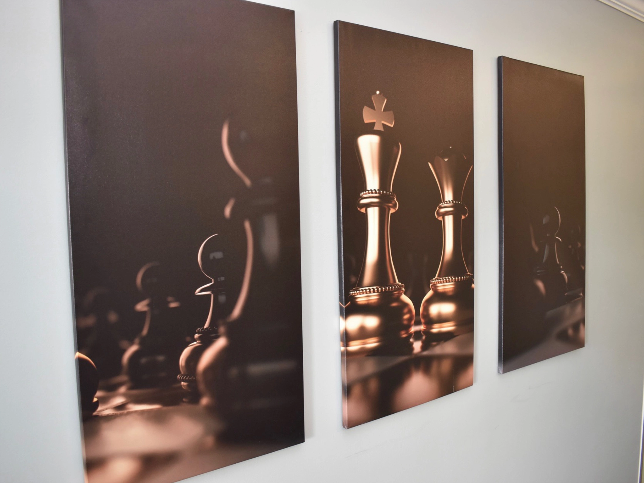 Chess Art on a wall made up of 3 different pictures.