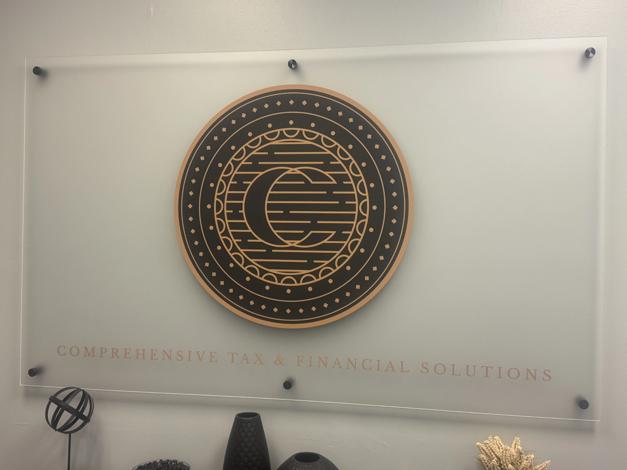 Comprehensive Tax and Financial Solutions Logo on wall art.